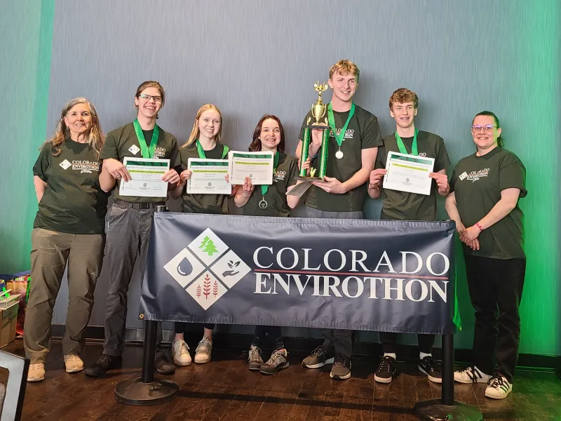 A group of high school students celebrates a win at the 2024 Colorado Envirothon competition