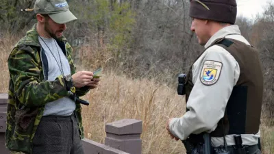 A conservation officer checks a hunting license
