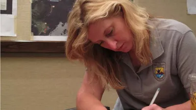 A natural resources manager completes paperwork at the end of the day