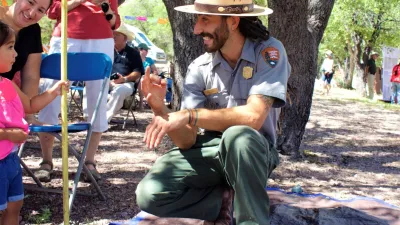 A national park ranger talks with a student