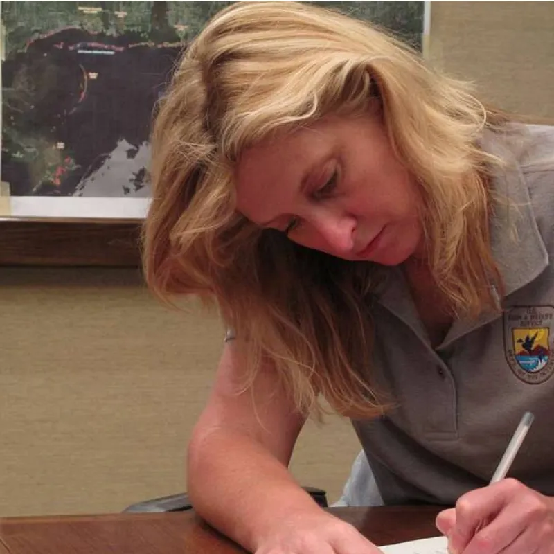 A natural resources manager completes paperwork at the end of the day